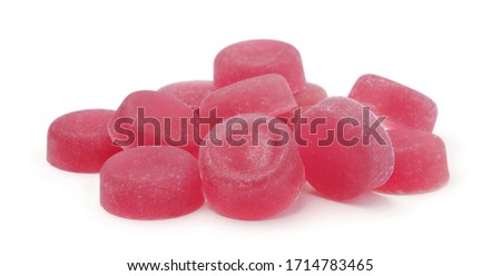 A pile of fruit red candies isolated on white background.