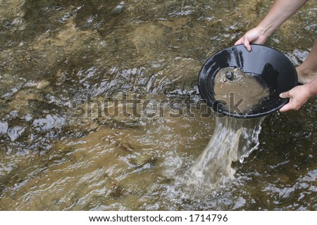 gold panning iin a small stream in northern michigan Royalty-Free Stock Photo #1714796