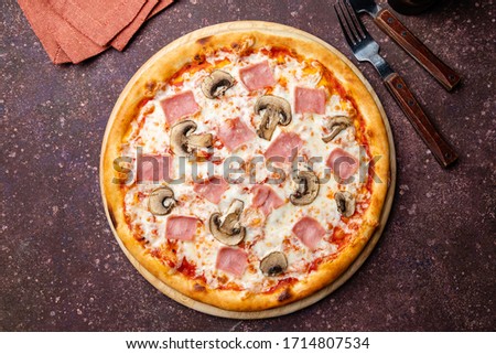 Pizza with ham and mushrooms on concrete table top view Royalty-Free Stock Photo #1714807534