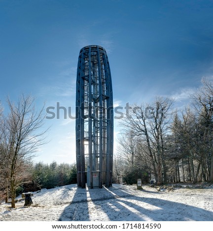 Winter countryside with snow and trees and Tesak observation tower, Czech Republic