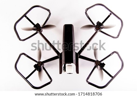 Video quadrocopter, photographer drone on white background front view with propeller protector.