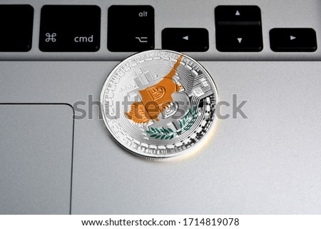 Bitcoin close-up on keyboard background, the flag of Cyprus is shown on bitcoin.