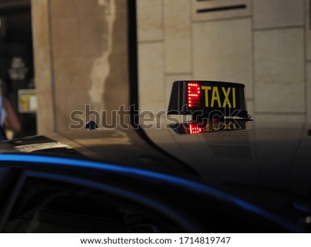 taxi sign on the roof of the car waiting for customers in the city