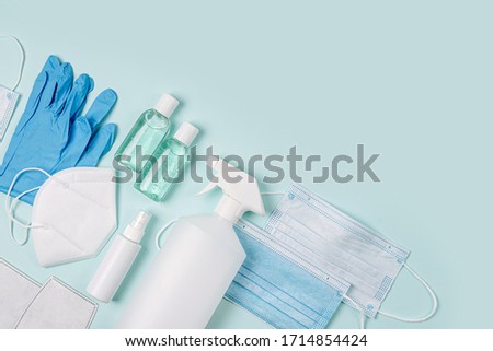 White medical masks and respirators with glove, hand sanitizer on blue background.  Face mask protection  KN95 or N95 and surgical masks for protection virus, flu, coronavirus, COVID-19.   Royalty-Free Stock Photo #1714854424