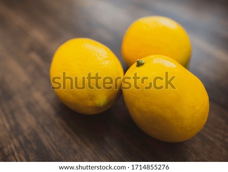Close up of Organic Fresh Lemon on Wood Texture Photo Background