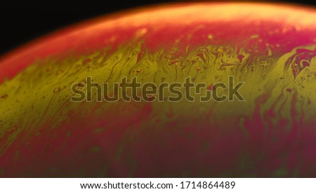 Soap bubbles abstract macro photo beautiful psychedelic abstraction red-yellow shades black background. sphere surface