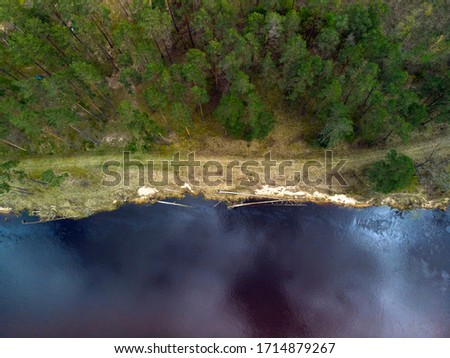 Top down view of Gauja river coastline with a cloud reflection