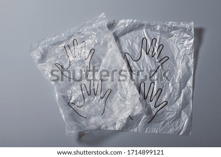 Disposable plastic protective gloves on gray background, close up shot, Prevention of infection with COVID-19 or SARS-CoV-2 coronavirus during shopping in the store