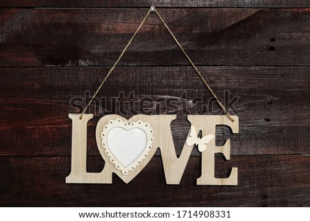 The inscription "love" on a wooden background. With space for your labels. Photo frame