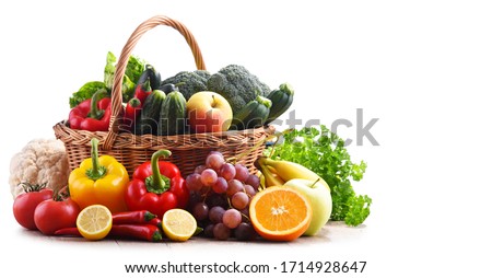 Assorted organic vegetables and fruits in wicker basket isolated on white background. Royalty-Free Stock Photo #1714928647