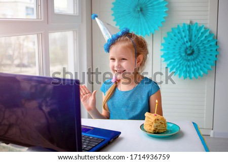 Happy girl  sibling celebrating birthday via internet in quarantine time, self-isolation and family values, online birthday party. Congratulations animator via laptop, online. Stay at home