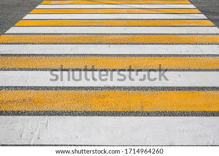 crosswalk on asphalt orange white