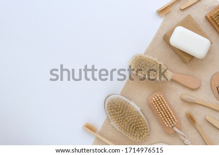Eco friendly wooden bamboo set for bathing on a white and beige background. Flat lay wooden spa accessories with copy space