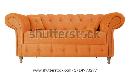 Orange sofa with pillows on wooden legs isolated on white. Orange suede couch isolated Royalty-Free Stock Photo #1714993297