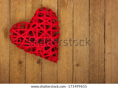 Red heart on a background of wood