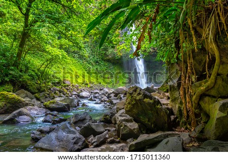 La Fortuna Waterfall in the forest with river, close to Arenal Volcano, Costa Rica national park. Central America. Royalty-Free Stock Photo #1715011360