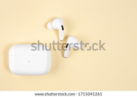 Air Pods Pro. with Wireless Charging Case. New Airpods pro on yellow background. Airpods Pro. Copy space.EarPods Royalty-Free Stock Photo #1715041261