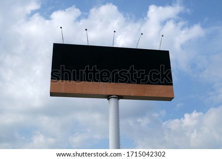 
Large empty bilboard poles with cloudy sky background