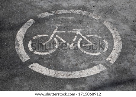 A painted cycle path sign on the ground
