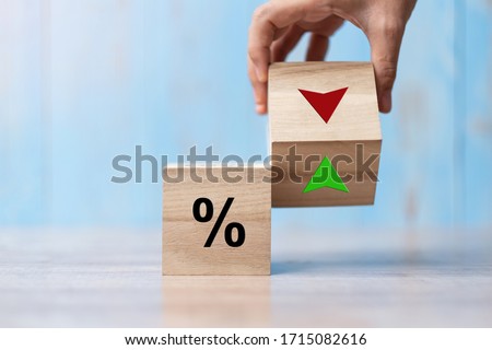 business man Hand change wood cube block with percentage to UP and Down arrow symbol icon. Interest rate, stocks, financial, ranking, mortgage rates and Cut loss concept