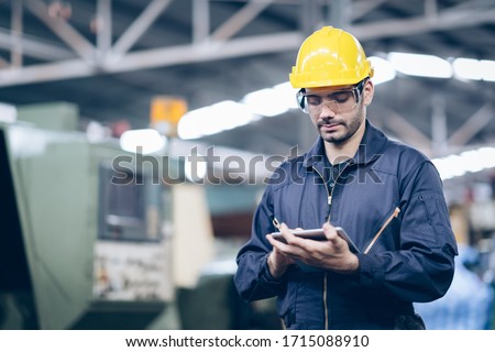 technician engineer standing and checking process on tablet in factory