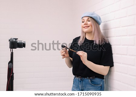 Beauty blogger (influencer) in front of the camera records video.