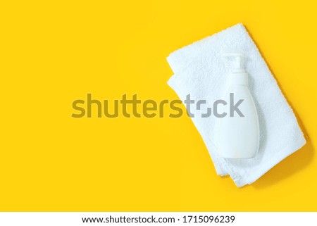 Sanitizer antiseptic gel liquid soap, white towel on yellow background. People are stocking up essentials for home quarantine. Consumer buying panic about coronavirus covid-19 concept, hygiene goods