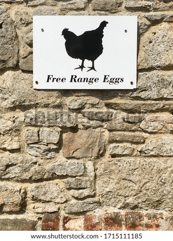 Free Range Eggs sign displayed on a stone wall.