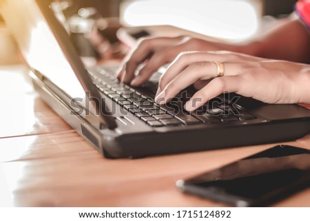 A close-up of a woman's hand using a keyboard on a laptop computer Business growth concept Royalty-Free Stock Photo #1715124892