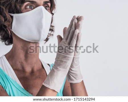 woman protecting from corona virus covid-19 wearing a protective face mask and medical latex gloves rubbing her hands