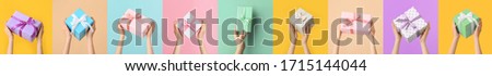 Female hands with beautiful gift boxes on colorful background