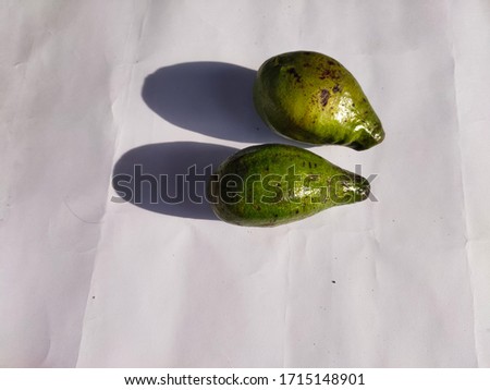 two green and ripe avocados