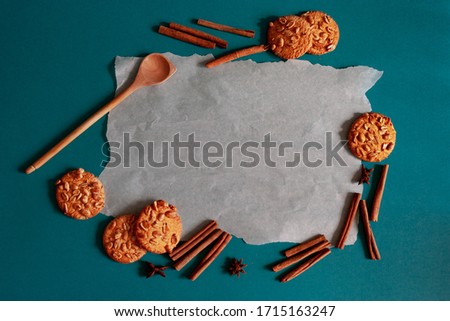 Cookies and cinnamon on a blue background. Oatmeal cookies with nuts, top view, flat layout, copy space. Concept of minimal background. place for text.
Background picture.