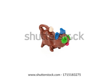 Children craft little cat molded from plasticine isolated on a white background