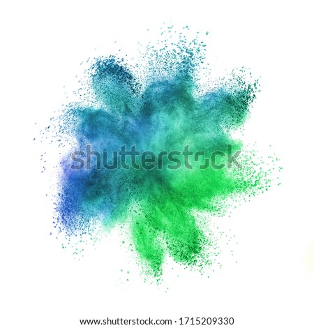 Abstract chaotic powder or dust explosion in green and blue colors on a white background with copy space. Royalty-Free Stock Photo #1715209330
