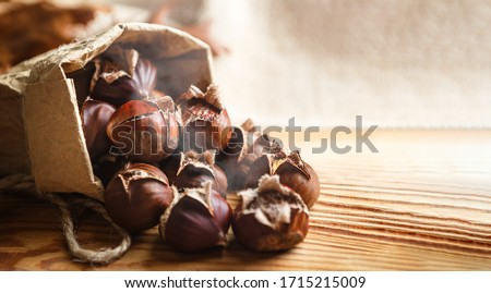 Chestnuts on a wooden background. Royalty-Free Stock Photo #1715215009