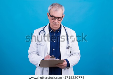 portrait of doctor writing some clinical reports