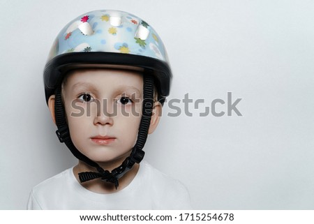 a boy in a helmet on a white background.