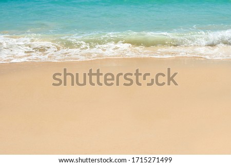  Blue sea and wave on clear sandy beach.