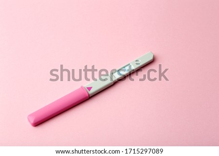 Pregnancy test on a blank colored background. Pregnancy, conception, and women's health. Birth of a baby concept.