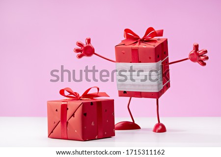 Gift in red box in protective mask, interesting inside. We defeat virus. Box on legs, with handles. Copy space.	