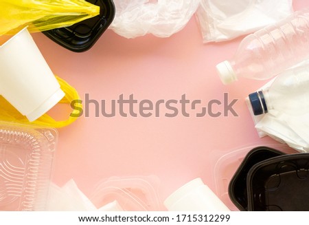 Frame of plastic waste on a pink background