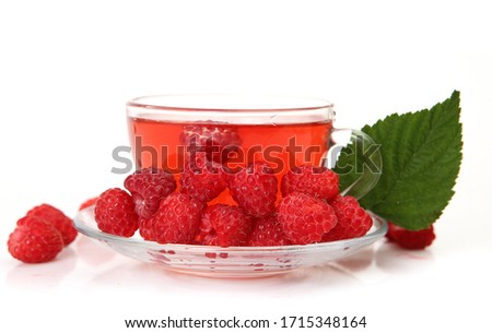 tea with ripe raspberries on a white background