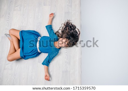 indoor studio photo of a child girl, top view