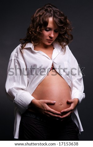 pregnant woman looking at her belly