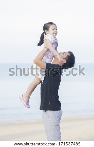 Portrait Of Asian Family walking On the Beach