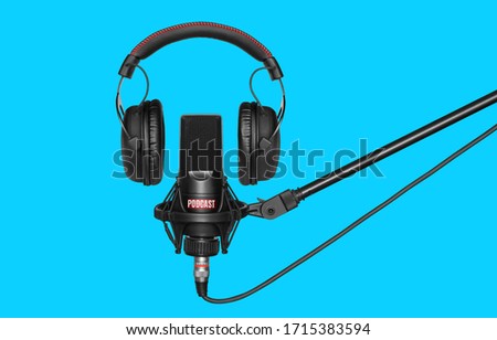microphone and headphones for recording podcasts over blue background Royalty-Free Stock Photo #1715383594