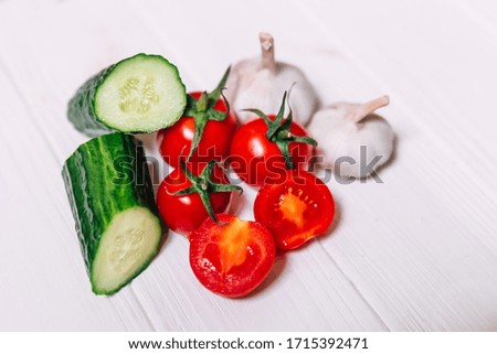 Fresh garlic cucumbers and tomatoes on wood. Book of recipes