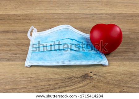 surgical mask and red heart, concept of love for protection from coronavirus covid-19