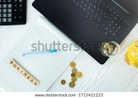 A freelancer's workspace with a laptop in a home office remote work or online learning concept, business banking and financial concepts. Selective focus.